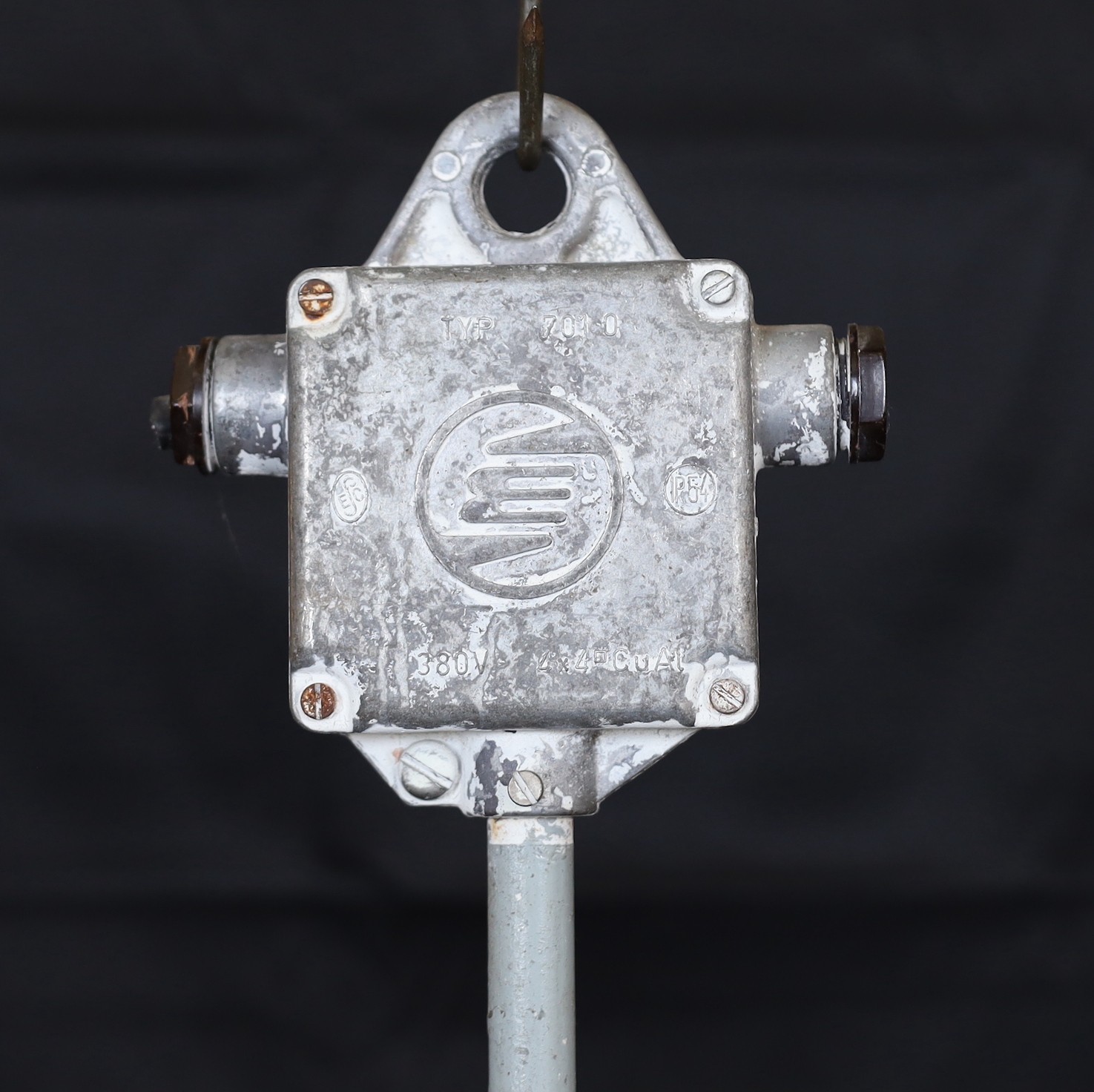 A pair of Czechoslovakian painted alloy industrial ceiling lights with caged Vaseline glass shades, height 74cm. width 21cm